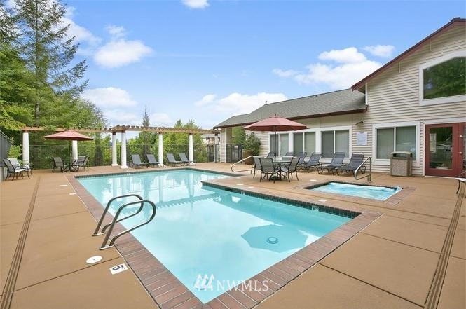 3918 243rd Place Southeast, Unit F304 Bothell, WA 98021 - Photo 25 of 25 a view of a patio with swimming pool table and chairs