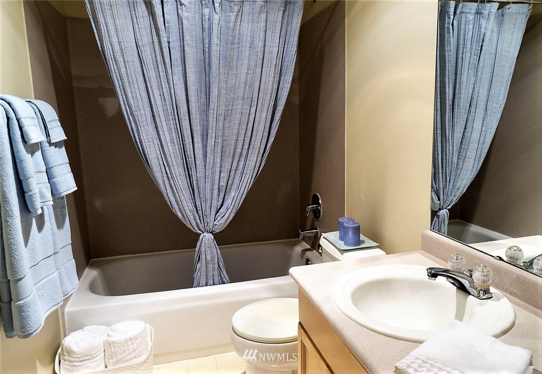 3918 243rd Place Southeast, Unit F304 Bothell, WA 98021 - Photo 7 of 25 a bathroom with a sink a toilet and tub