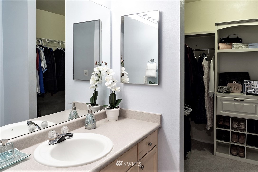 3918 243rd Place Southeast, Unit F304 Bothell, WA 98021 - Photo 10 of 25 a bathroom with a sink and a mirror
