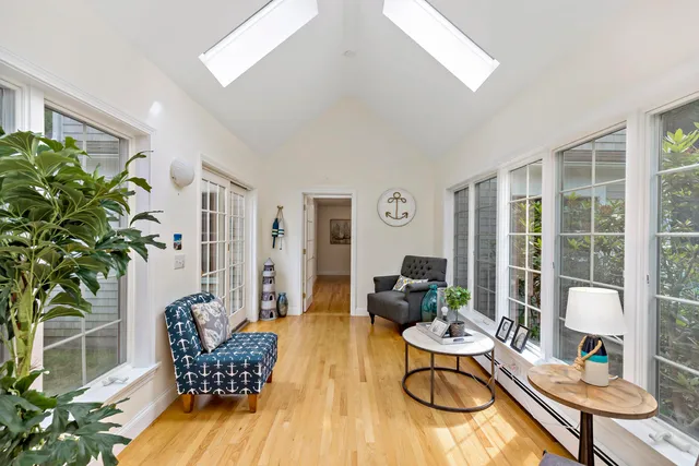 a living room with furniture dining table and a potted plant