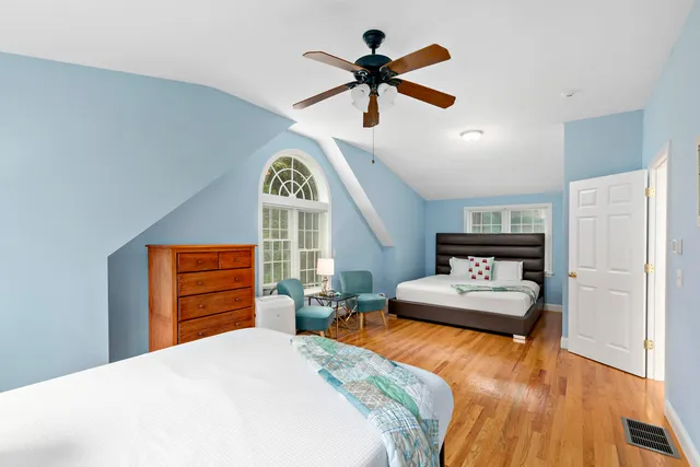 a bedroom with a bed dresser and a window