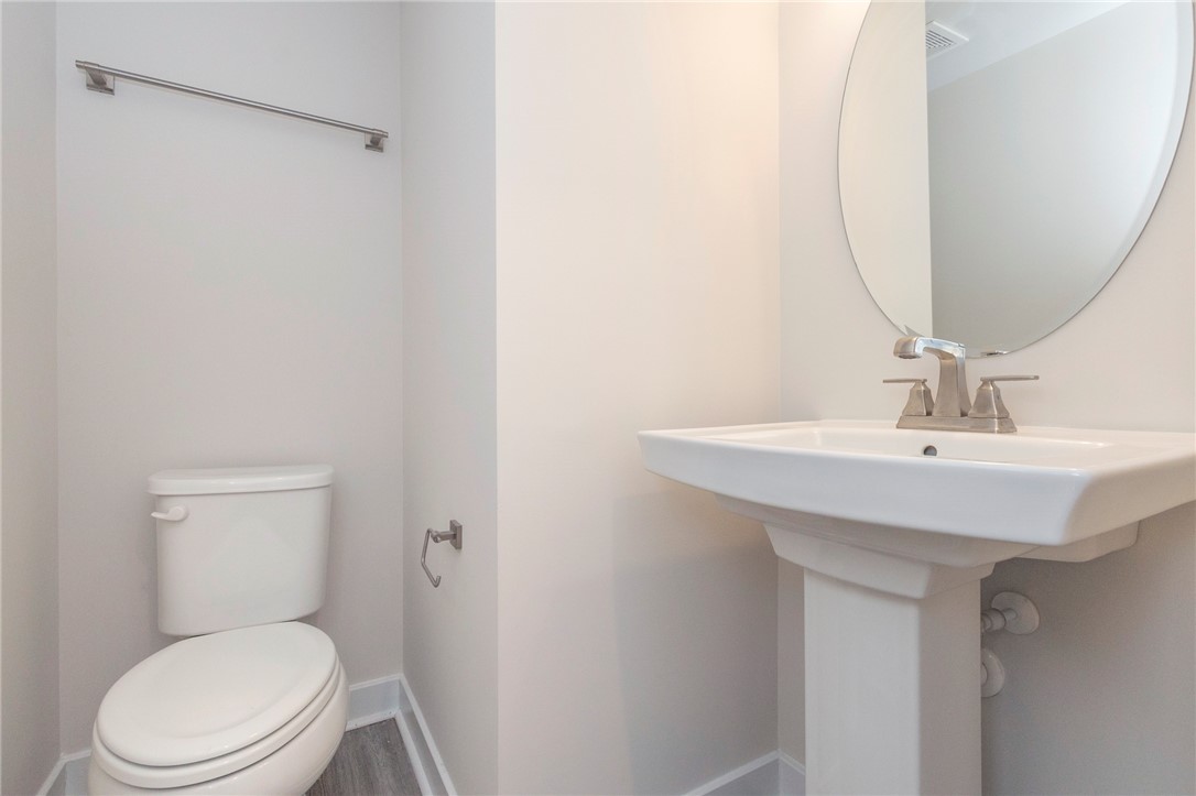 233 Scenic Road Anderson, SC 29621 - Photo 20 of 50 A compact and functional bathroom features a modern pedestal sink and mirror.