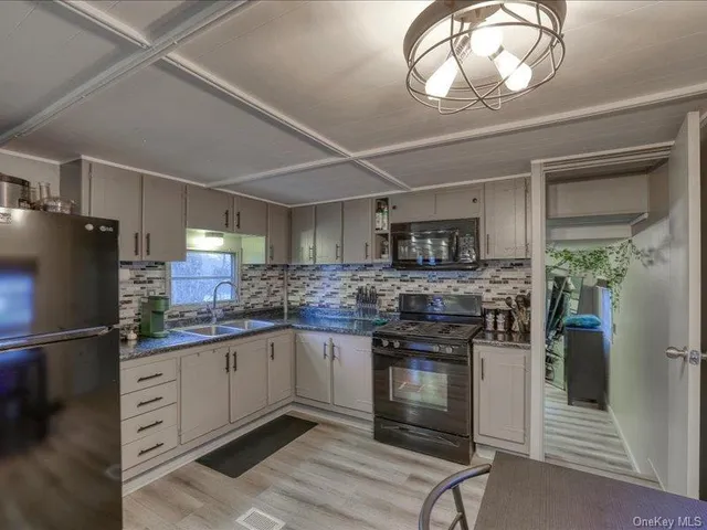 a kitchen with stainless steel appliances granite countertop a stove and a refrigerator