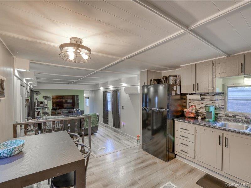 165 Lattintown Road, Unit LOT 60 Newburgh, NY 12550 - Photo 24 of 24 Kitchen featuring light wood-type flooring, freestanding refrigerator, backsplash, and open floor plan