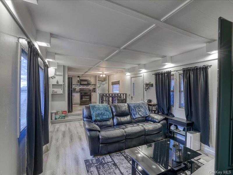 165 Lattintown Road, Unit LOT 60 Newburgh, NY 12550 - Photo 16 of 24 Living area featuring light wood-style flooring, coffered ceiling, and beamed ceiling