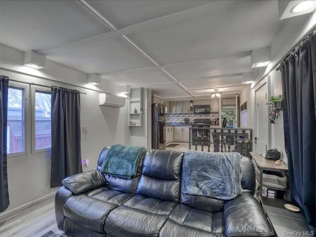 a living room with furniture a ceiling fan and a wooden floor