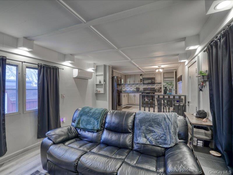 165 Lattintown Road, Unit LOT 60 Newburgh, NY 12550 - Photo 18 of 24 a living room with furniture and a glass door