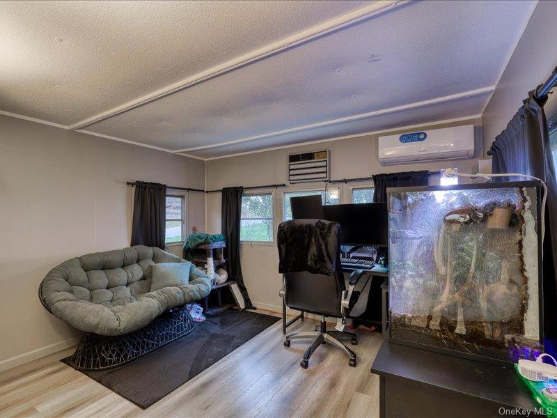 165 Lattintown Road, Unit LOT 60 Newburgh, NY 12550 - Photo 21 of 24 Office area featuring wood finished floors, an AC wall unit, a textured ceiling, and crown molding