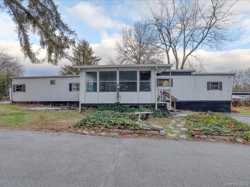 165 Lattintown Road, Unit LOT 60 Newburgh, NY 12550 - Photo 3 of 24 a view of a house with a yard and large tree