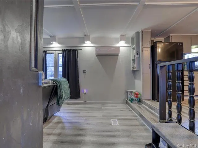 a bedroom with a bed and a mirror