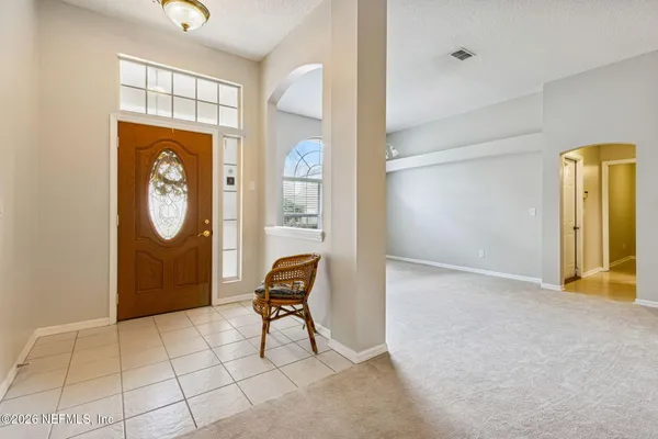 a kitchen with granite countertop white cabinets stainless steel appliances and a sink