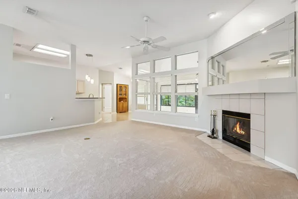 a kitchen with granite countertop a sink and white cabinets