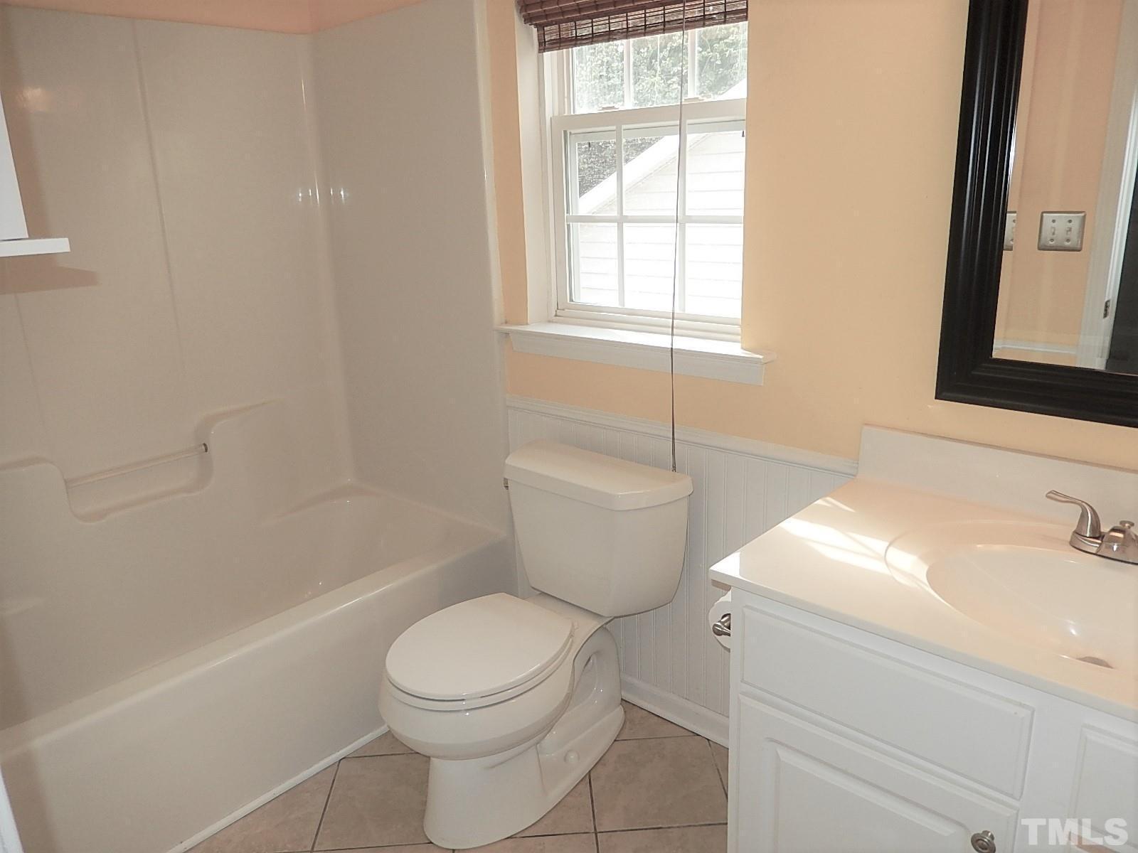 4717 Delta Ridge Court Raleigh, NC 27612 - Photo 24 of 30 a white toilet sitting next to a bath tub