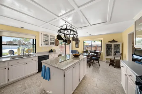 a very nice looking open kitchen with a large island in the center