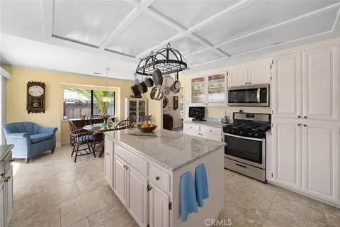 a kitchen with stainless steel appliances granite countertop a stove and a refrigerator