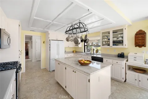 a kitchen that has a lot of cabinets in it