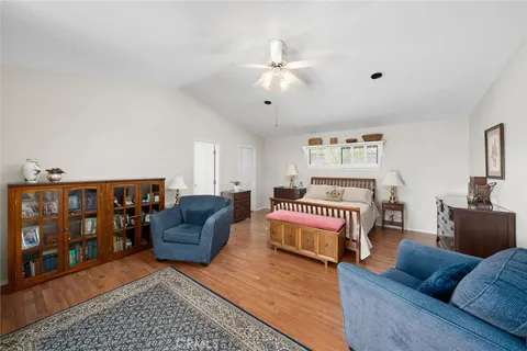 a bedroom with furniture and wooden floor