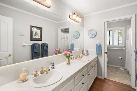 a bathroom with a double vanity sink and a mirror