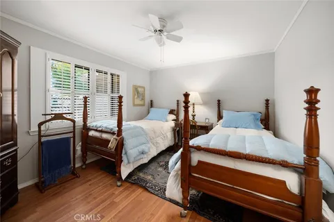 a bedroom with two beds and a chandelier
