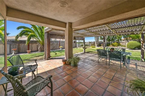 a view of a patio with table and chairs and potted plants