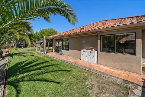 a view of a house with backyard and sitting area