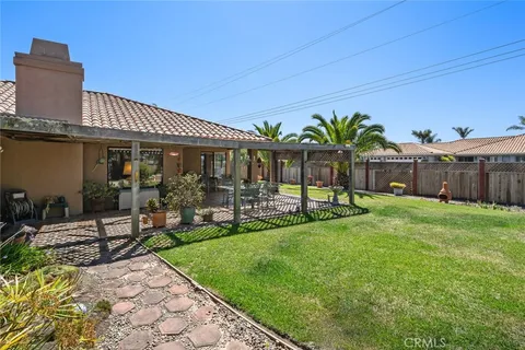 a view of a house with backyard porch and sitting area
