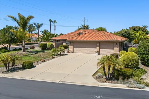 a view of a house with a yard and sitting area
