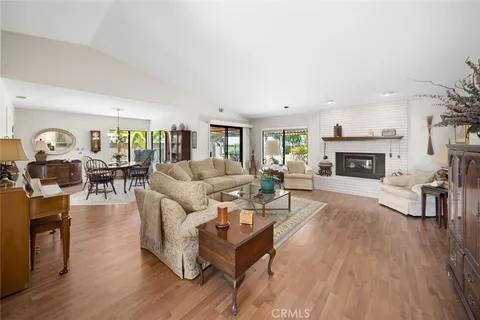 a living room with fireplace furniture and a wooden floor