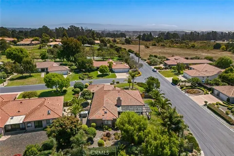 an aerial view of a houses with a lake view
