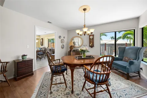 a view of a dining room with furniture wooden floor livingroom and chandelier