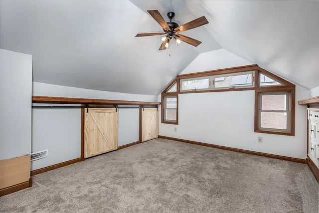 a white bath tub sitting next to a white sink and a window