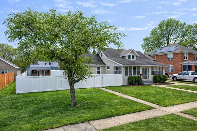 a view of a house with a small yard and a large window