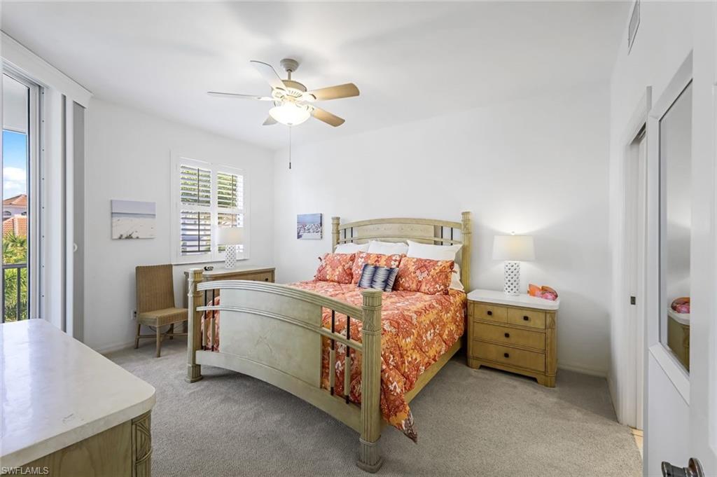 470 Launch Circle, Unit V301 Naples, FL 34108 - Photo 14 of 39 a bedroom with a bed and a chandelier