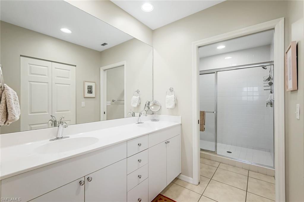 470 Launch Circle, Unit V301 Naples, FL 34108 - Photo 16 of 39 a bathroom with a shower sink and mirror