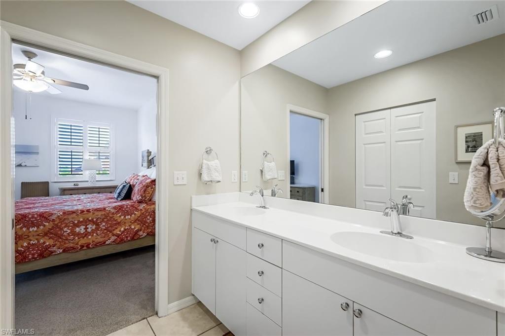 470 Launch Circle, Unit V301 Naples, FL 34108 - Photo 17 of 39 a en suite bathroom with double sink and a large mirror