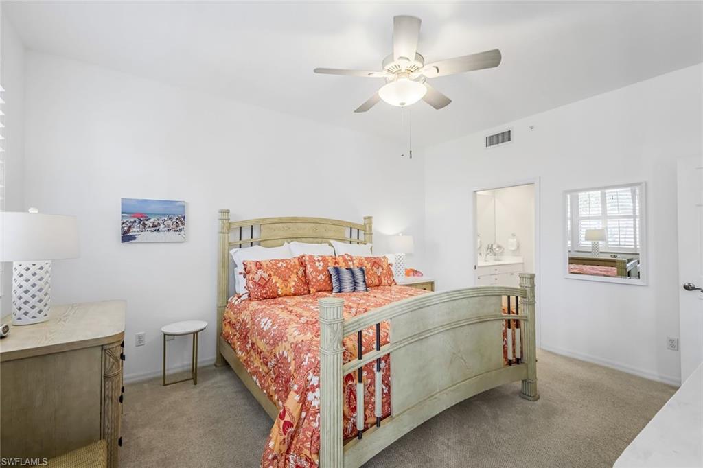 470 Launch Circle, Unit V301 Naples, FL 34108 - Photo 18 of 39 a bedroom with a bed and a chandelier
