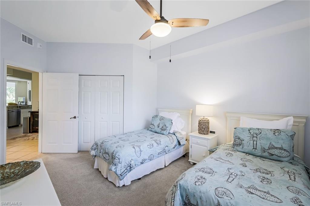 470 Launch Circle, Unit V301 Naples, FL 34108 - Photo 19 of 39 a bedroom with two beds and painted walls