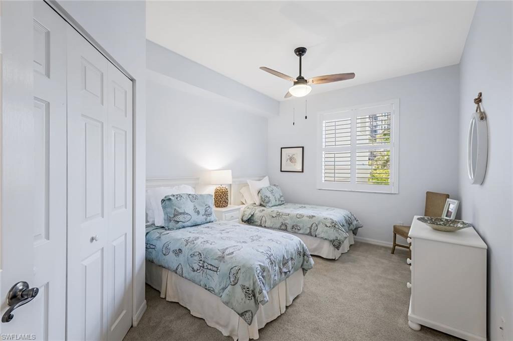 470 Launch Circle, Unit V301 Naples, FL 34108 - Photo 22 of 39 a bedroom with two beds and a window