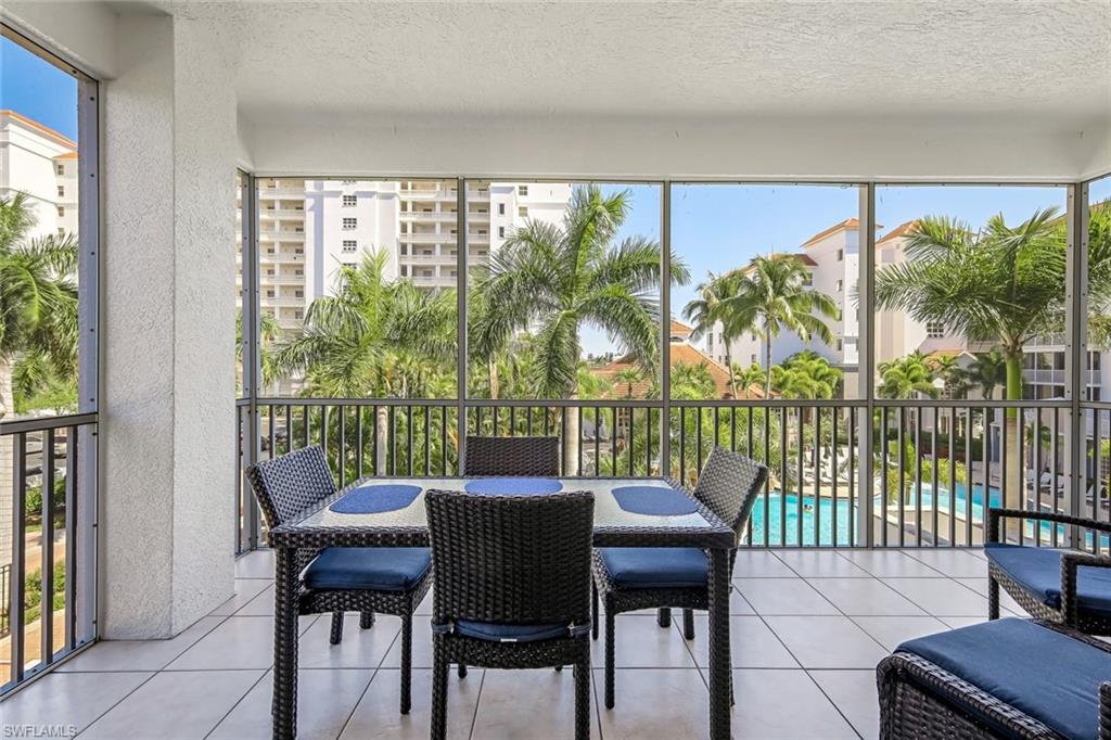 470 Launch Circle, Unit V301 Naples, FL 34108 - Photo 3 of 39 a dining room with furniture and a floor to ceiling window