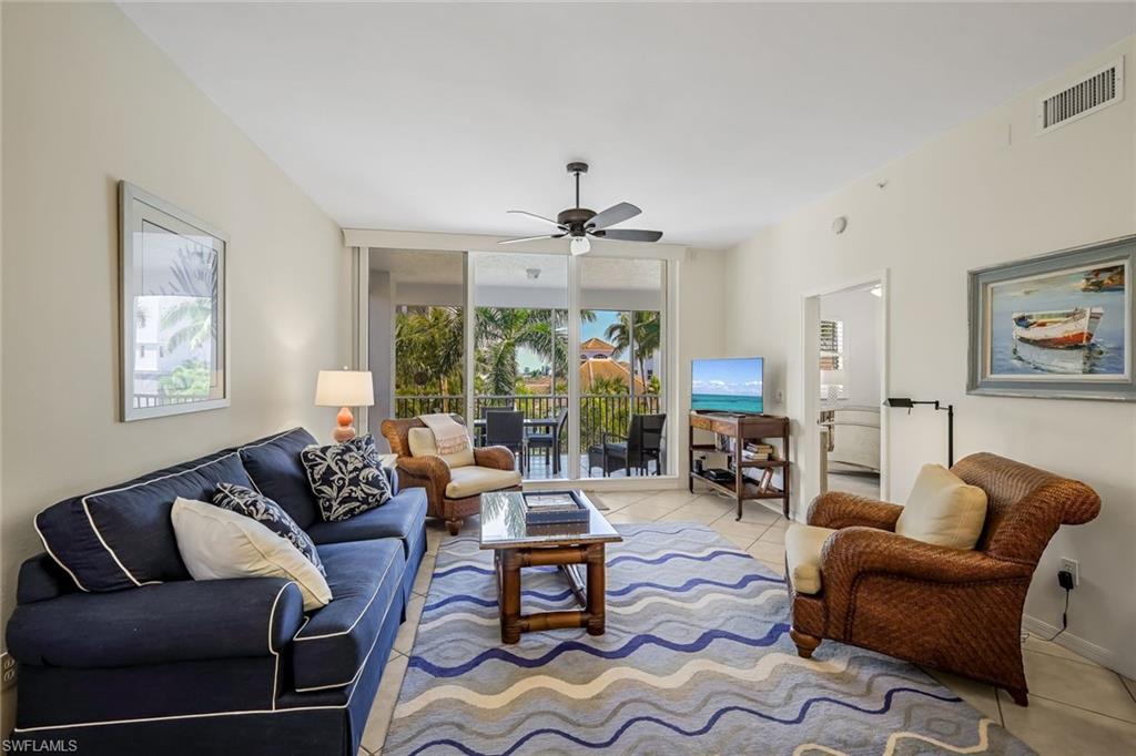 470 Launch Circle, Unit V301 Naples, FL 34108 - Photo 6 of 39 a living room with furniture ceiling fan and a window