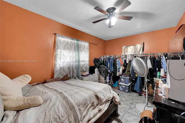 a large bed sitting in a bedroom next to a window