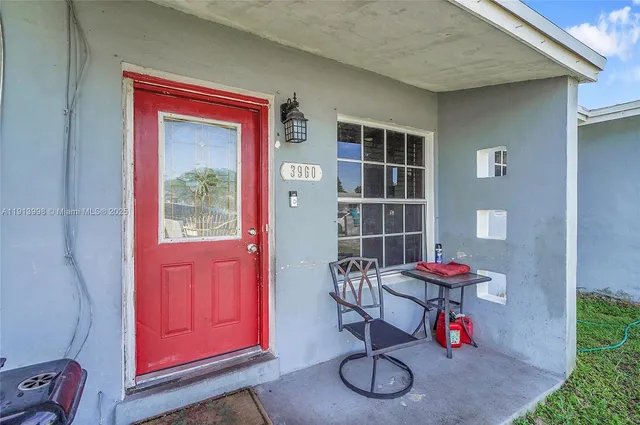 an outdoor dining space with red door