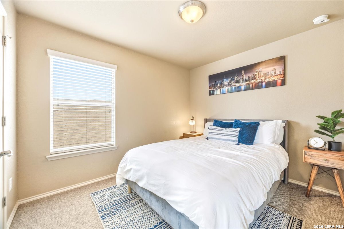 3831 Bacall Way Converse, TX 78109 - Photo 23 of 33 a bedroom with a bed and a window