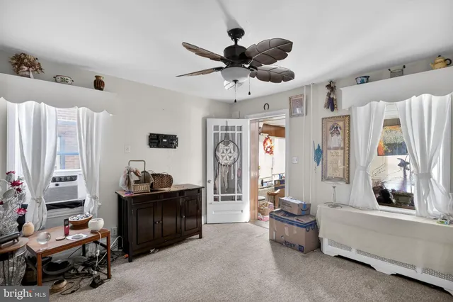 a view of a dining room with furniture and a chandelier