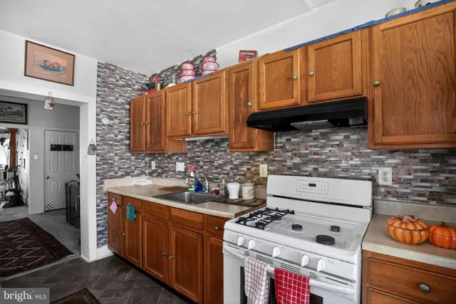 a kitchen with stainless steel appliances a stove a refrigerator and a sink