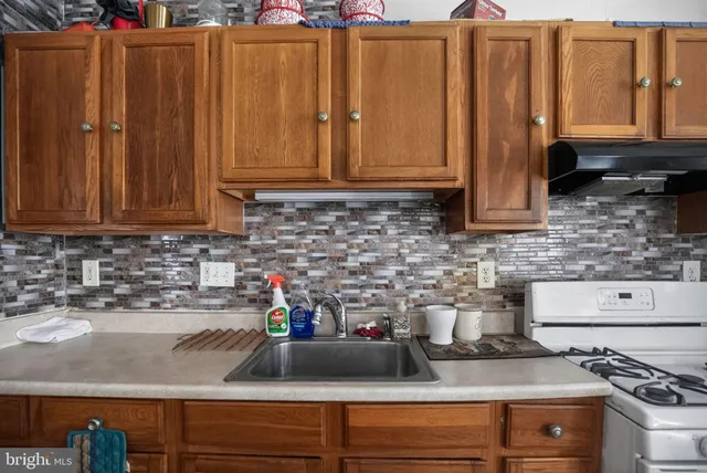 a living room with furniture fireplace and a window