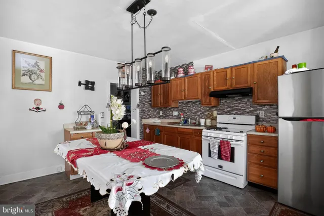 a kitchen with a sink refrigerator and cabinets