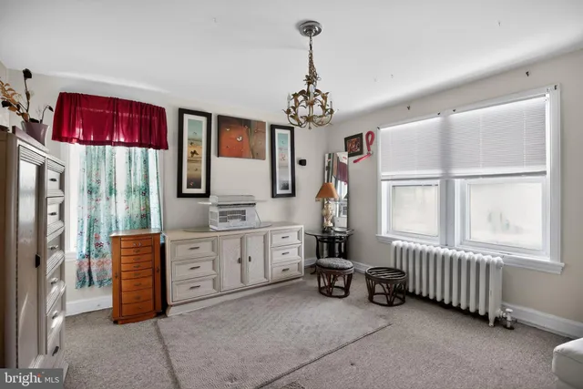 a room with furniture a chandelier a mirror and shower