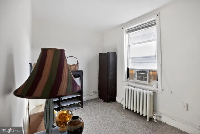 a bedroom with furniture and window