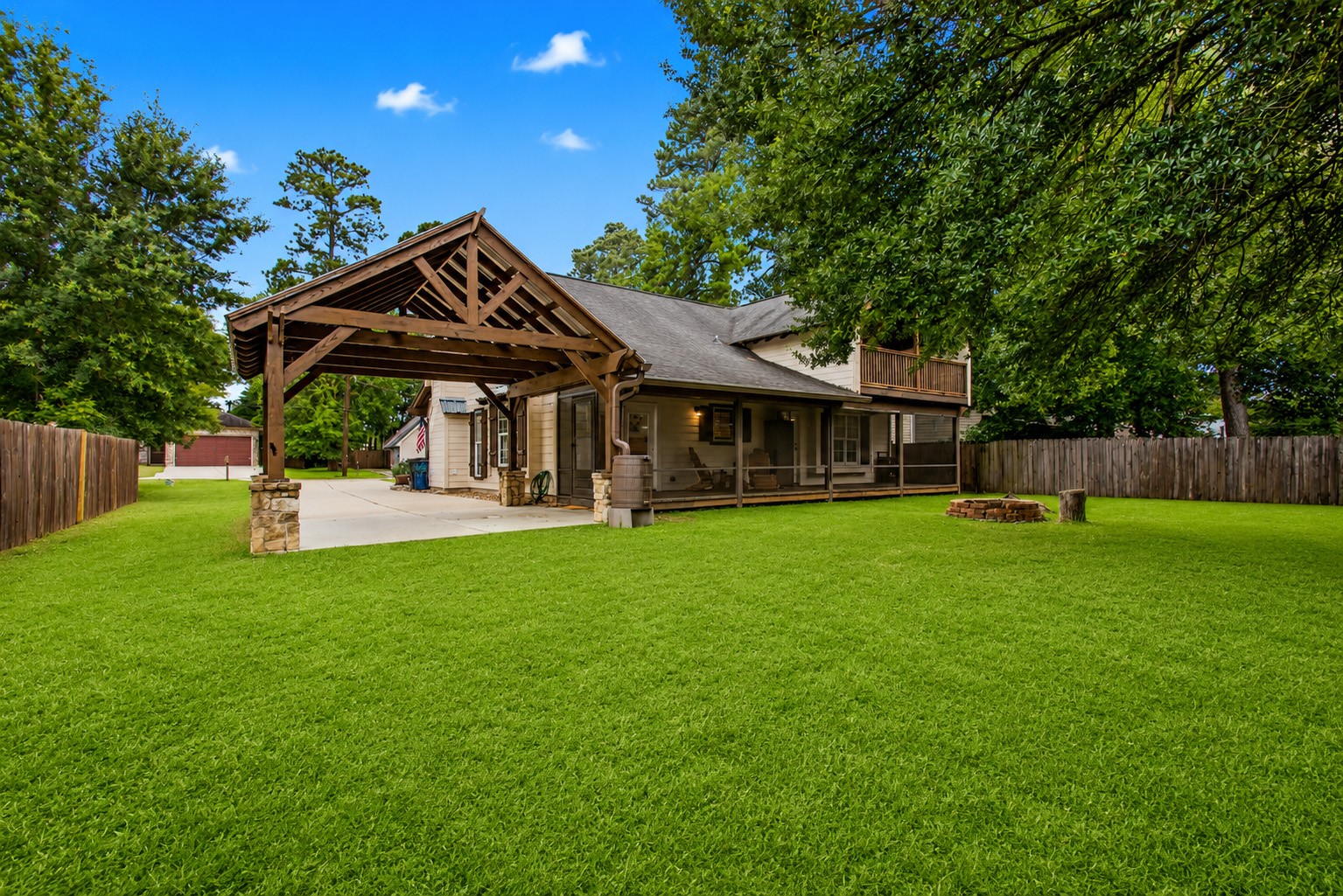 312 Springwood Drive Conroe, TX 77385 - Photo 45 of 50 Custom farmhouse-style carport provides covered parking and adds unique character to the home.